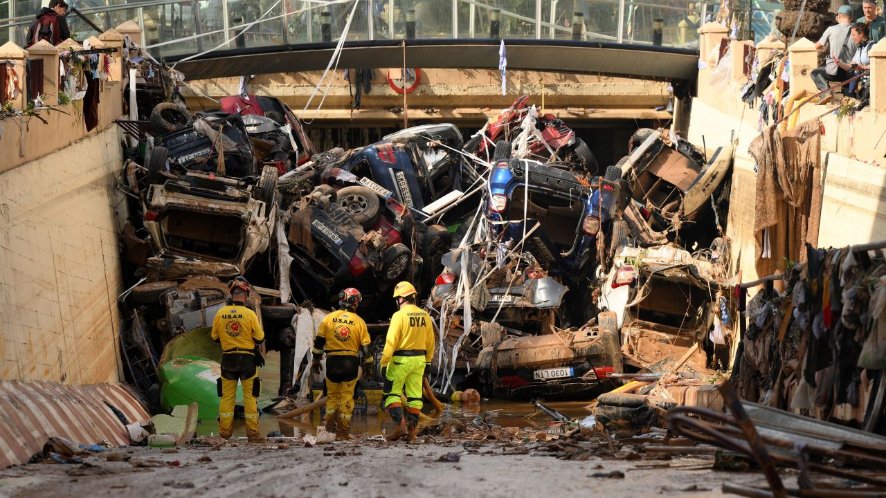 Members of a fire brigade search and rescue unit work as cars and debris block a tunnel after flash flooding in the Benetusser municipality of Valencia, Spain.