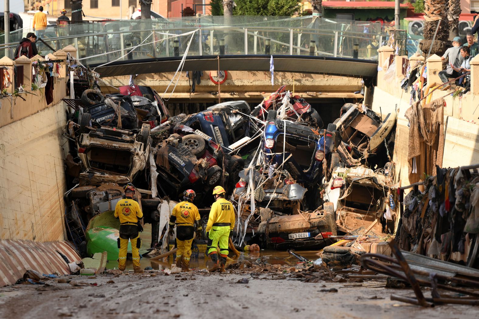 Firefighters conduct search-and-rescue efforts as cars and debris block a tunnel in Benetússer on Friday.