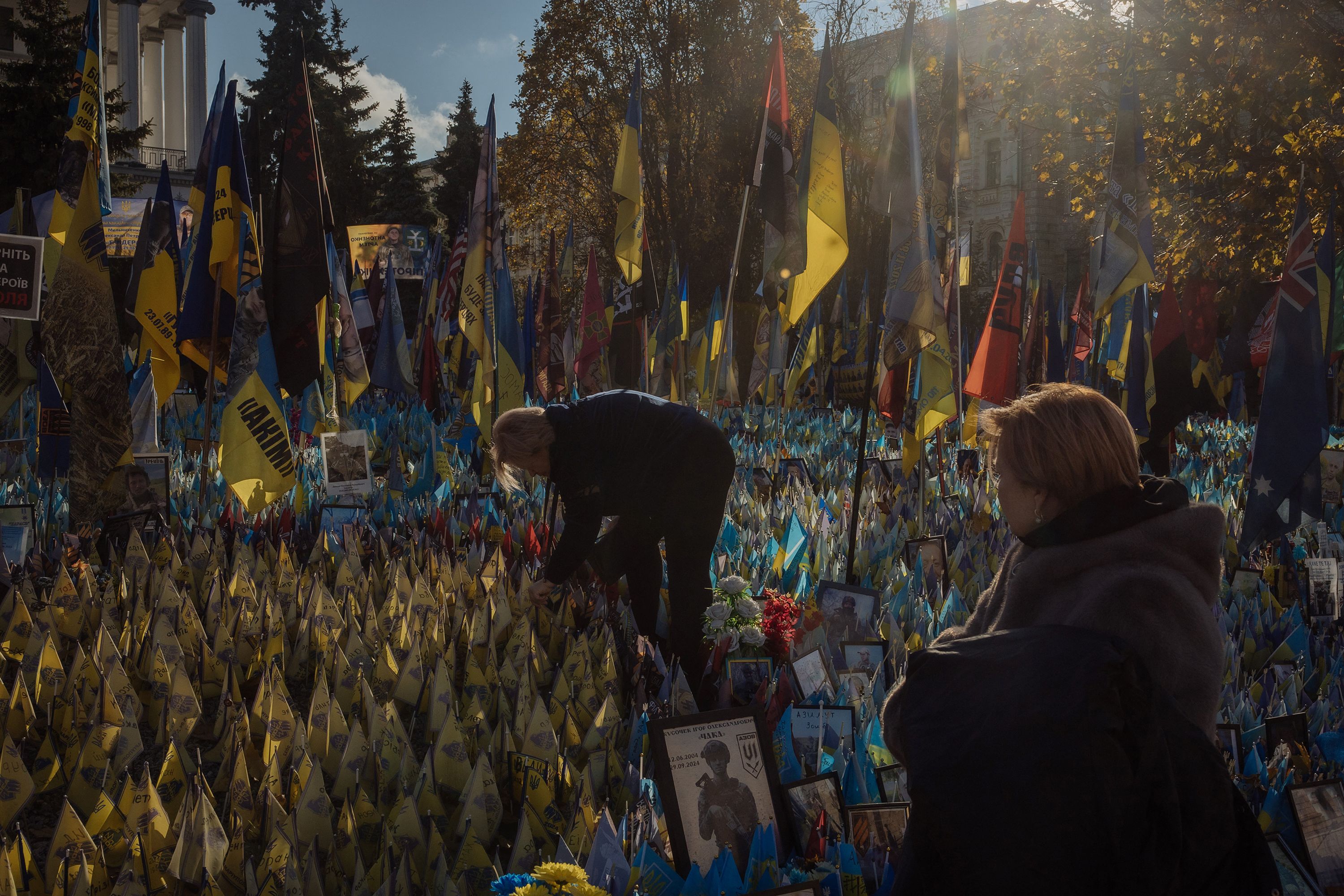 People in Kyiv, Ukraine, visit a makeshift memorial paying tribute to Ukrainian and foreign fighters on Tuesday, November 19.