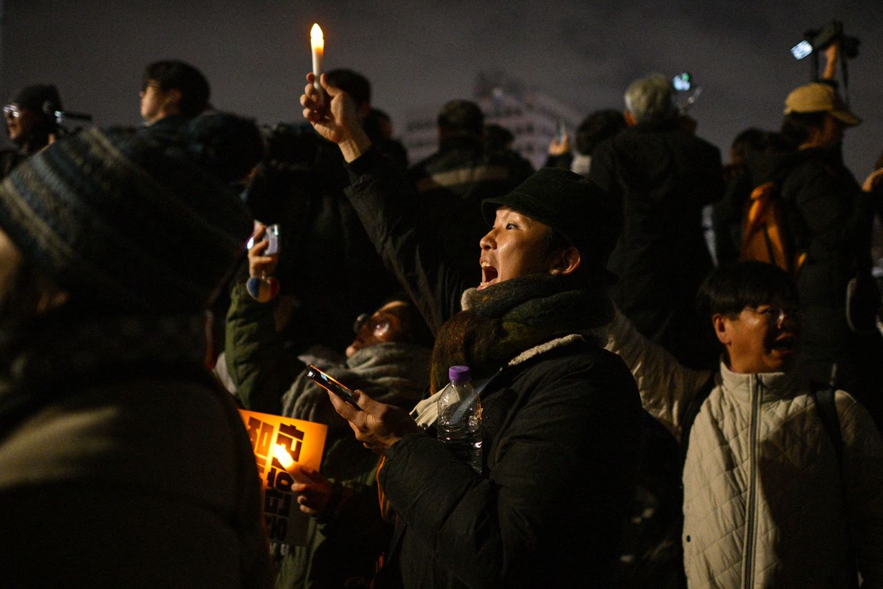 People gather outside the National Assembly in Seoul, South Korea on December 4, 2024, after South Korea President Yoon Suk Yeol declared martial law.