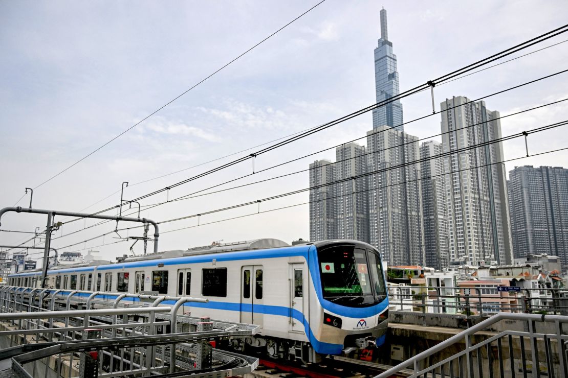 A train of the Line 1 of the HCMC Metro is seen passing by residential buildings in Ho Chi Minh City.