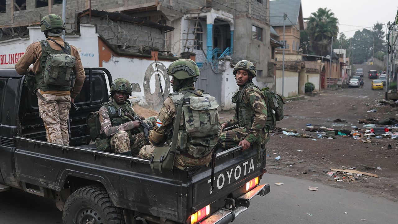 Members of the M23 armed group ride in a pickup truck during a patrol in Goma on January 29, 2025.