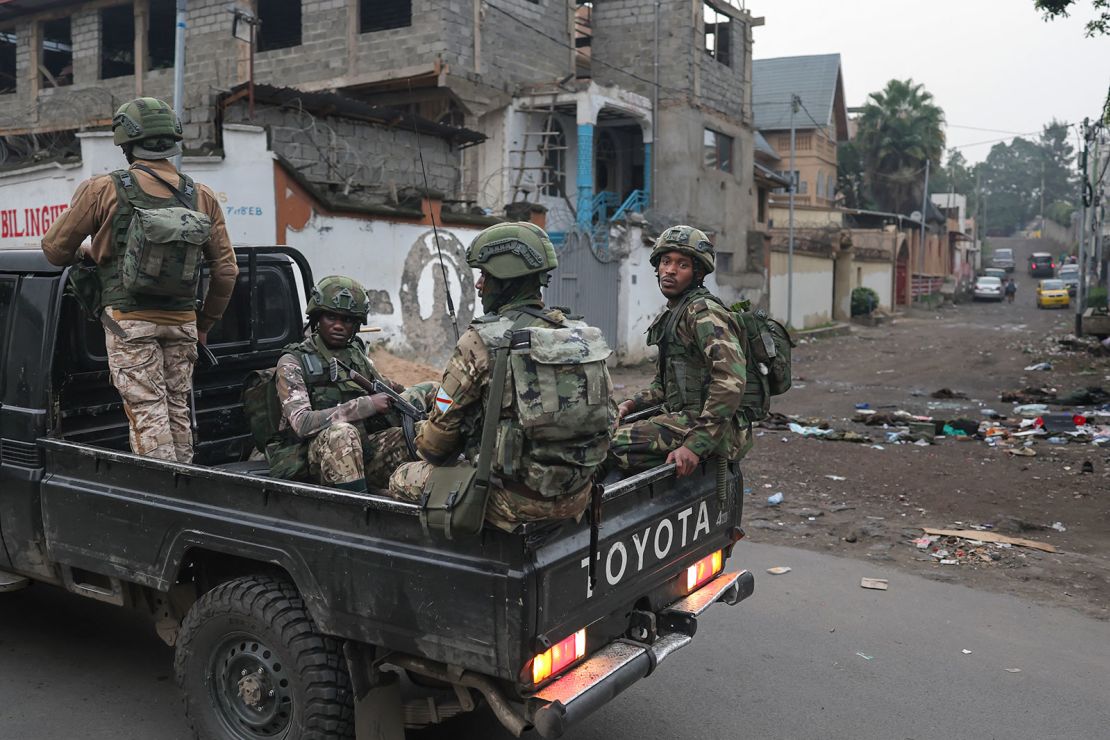 Members of the M23 armed group ride in a pickup truck during a patrol in Goma on January 29.