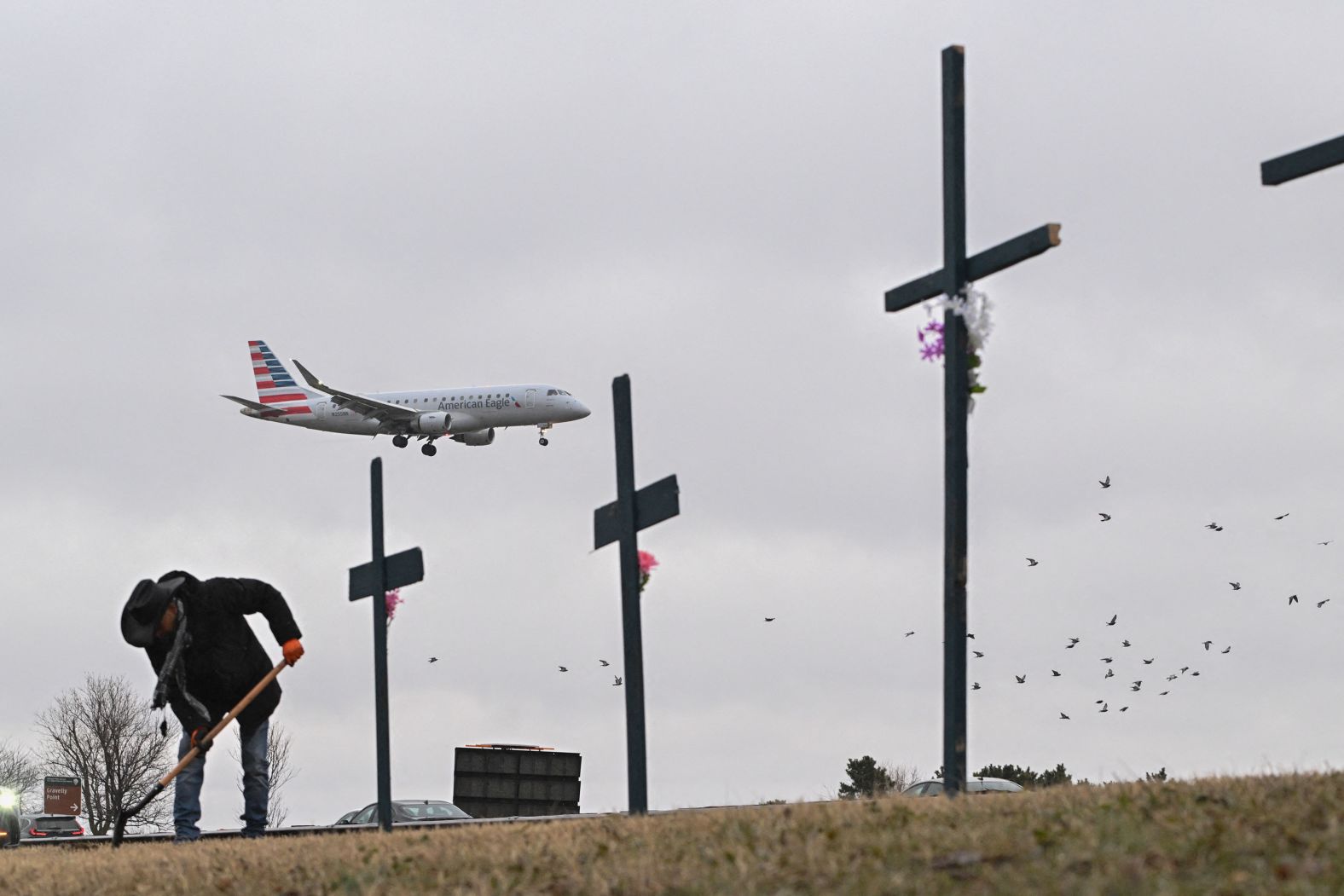 Roberto Marquez helps set up the makeshift memorial near the airport on Friday.