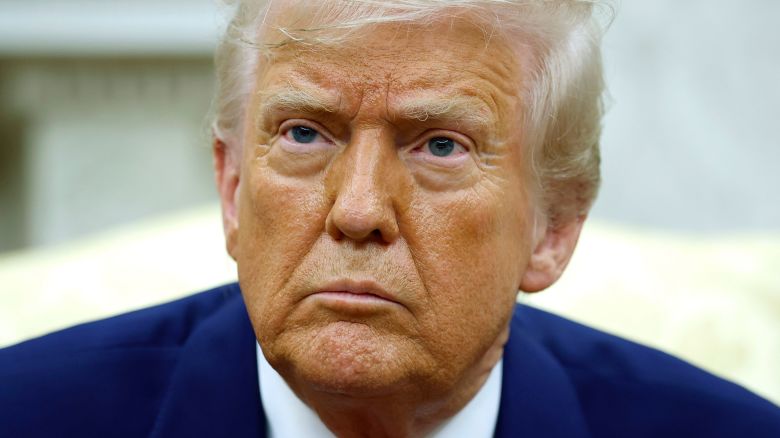 President Donald Trump answers a reporters question in the Oval Office of the White House on Monday.
