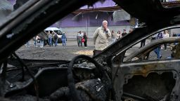 TOPSHOT - An elderly woman reacts as she looks at burned cars parked outside a mall following a night-time drone attack on Kyiv, on May 4, 2025 amid the Russian invasion of Ukraine. (Photo by Sergei SUPINSKY / AFP) (Photo by SERGEI SUPINSKY/AFP via Getty Images)          