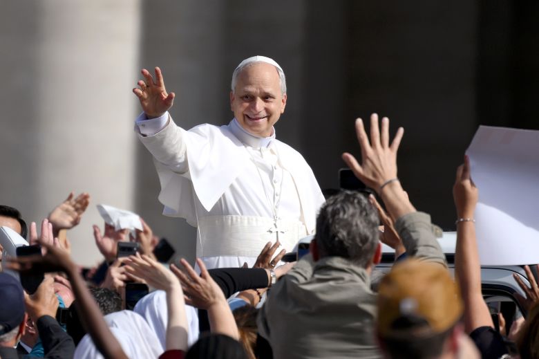 Pope Leo waves as he arrives ahead of his inaugural Mass in Vatican City in May.