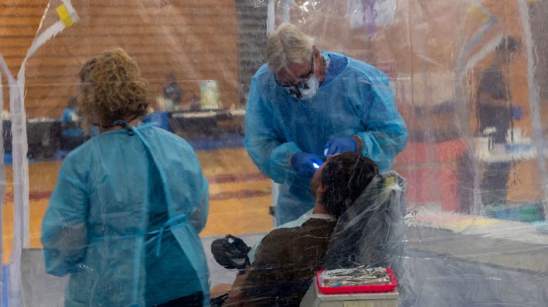 TERRE HAUTE, INDIANA - AUGUST 02: Dentists care for patients at a Remote Area Medical (RAM) mobile dental and medical clinic at Terre Haute South High School on August 02, 2025 in Terre Haute, Indiana. More than a thousand people are expected to seek free dental, medical, and vision care at the two-day event in Terre Haute, which has a poverty rate of over 25 percent. Non-profit organization RAM provides free medical care through mobile clinics in underserved, isolated, or impoverished communities around the country and world. As healthcare continues to be a contentious issue in the U.S., an estimated 27 million people — or 8.3 percent of the population — are uninsured, according to a report from the Census Bureau, with the rate considerably higher in rural and poorer parts of the country. (Photo by Spencer Platt/Getty Images)