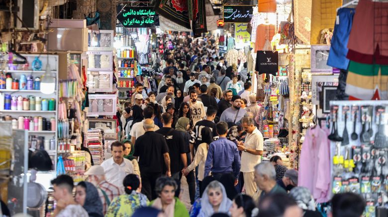 Iranians walk past shops in the Grand Bazaar in Tehran on August 13, 2025. Britain, France and Germany have told the United Nations they are ready to reimpose UN-mandated sanctions on Iran over its nuclear programme if no diplomatic solution is found by the end of August, according to a joint letter obtained by AFP.