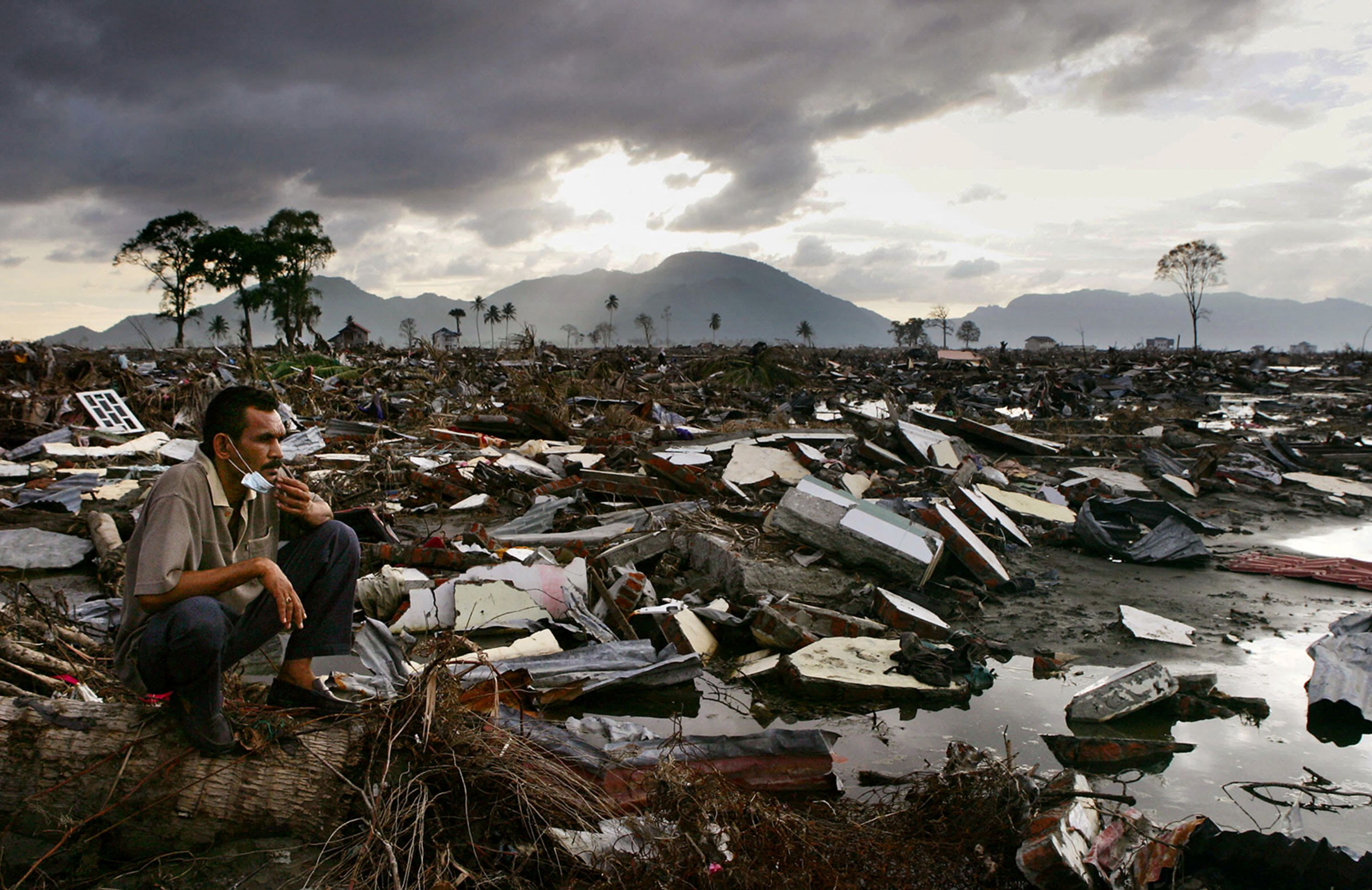 A man surveys tsunami damage in Banda Aceh, Indonesia, in January 2005.