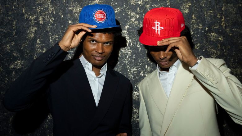From Left, twin brothers and basketball players Ausar and Amen Thompson with their new team caps after the NBA draft in New York, on June 22, 2023. Amen Thompson was drafted fourth by the Houston Rockets last week; Ausar Thompson was taken fifth, by the Detroit Pistons. (Maansi Srivastava/The New York Times)