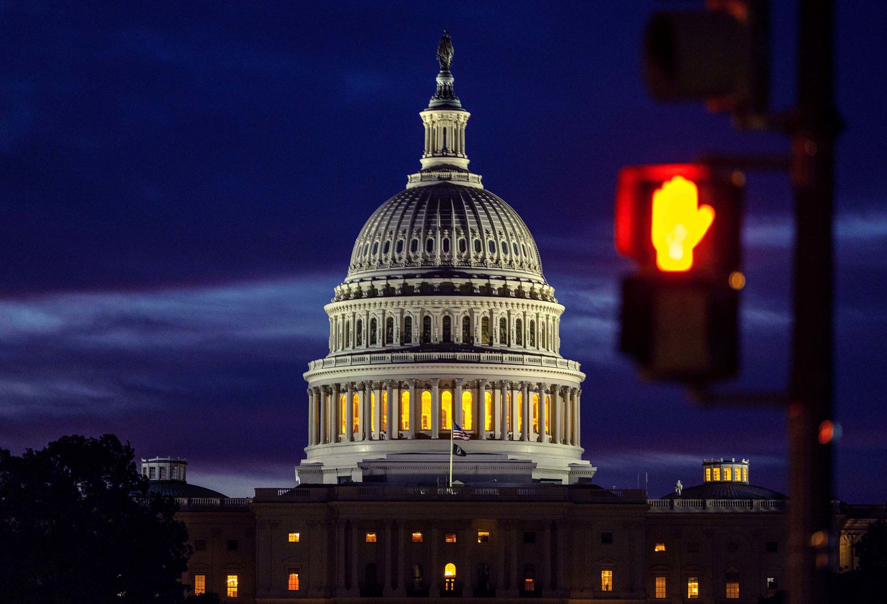 The sun rises at the US Capitol in Washington, DC, on Wednesday, October 1, the morning after the government shut down.