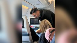 Dr. TJ Trad helps a man on a flight from Uganda.