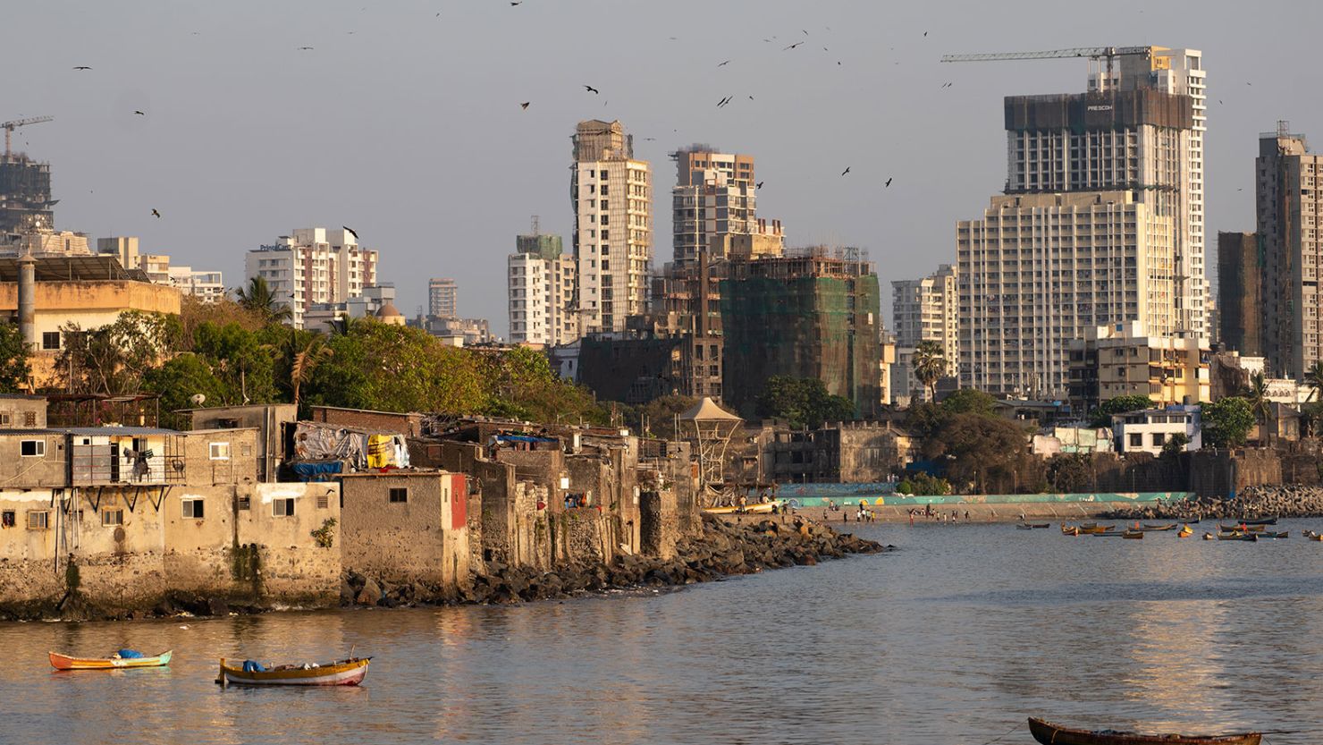 Slums are seen near commercial high-rise buildings in Mumbai, India, on April 14, 2024.