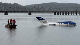 A business jet sits in the water 100 feet past the end of the runway at Southwest Oregon Regional Airport where it skidded off the runway around 6 a.m. local time Monday morning.