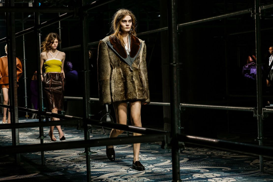 Paperbag-waist skirts and faux fur coats featured on the Prada Fall-Winter 2025 runway.