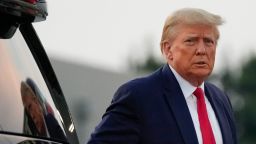 Former President Donald Trump walks to speak with reporters before departure from Hartsfield-Jackson Atlanta International Airport on August 24 in Atlanta, Georgia.