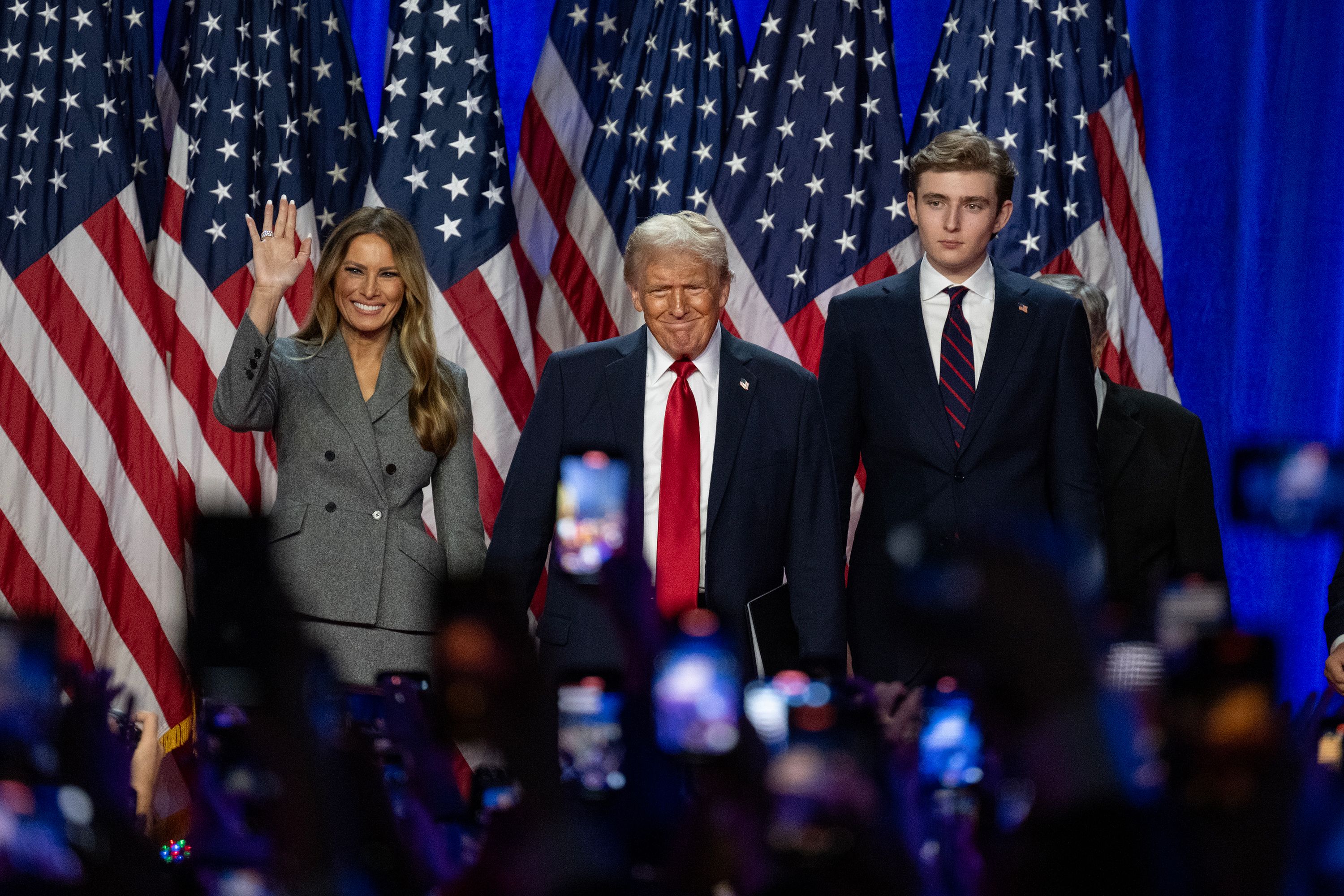 Former President Donald Trump appears with his wife, Melania, and son Barron on stage at his election night watch party in West Palm Beach, Florida, on Wednesday, November 6.