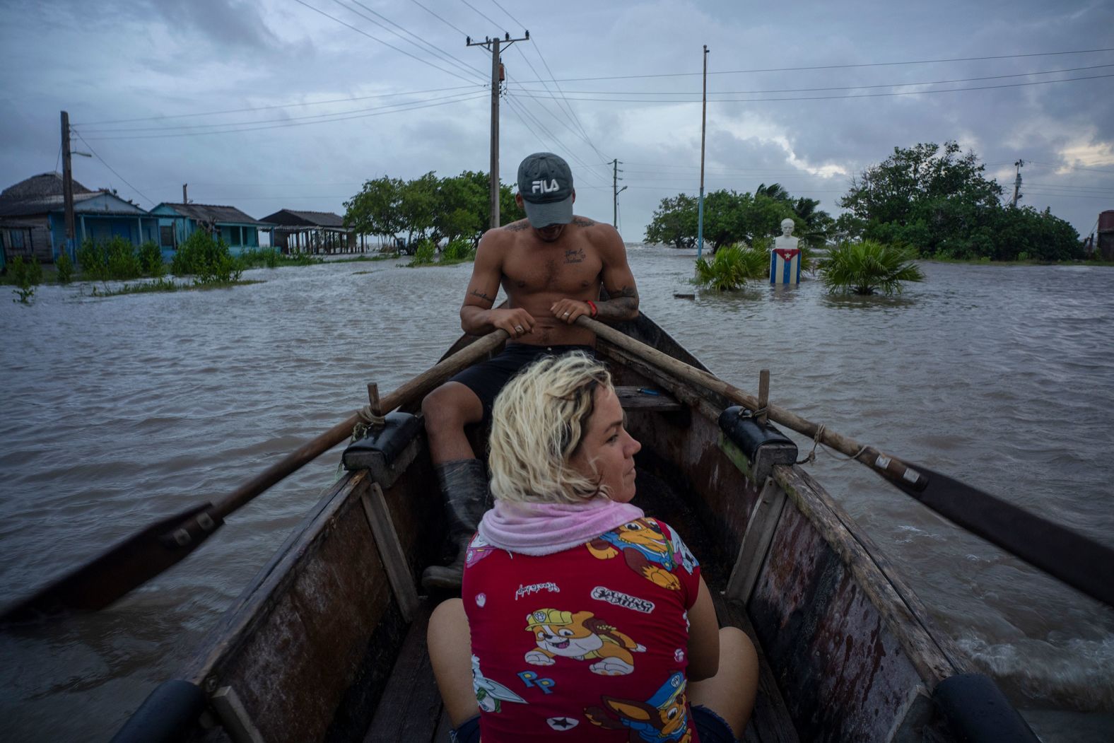 People in Guanimar, Cuba, traverse a flooded street in a boat on September 25.