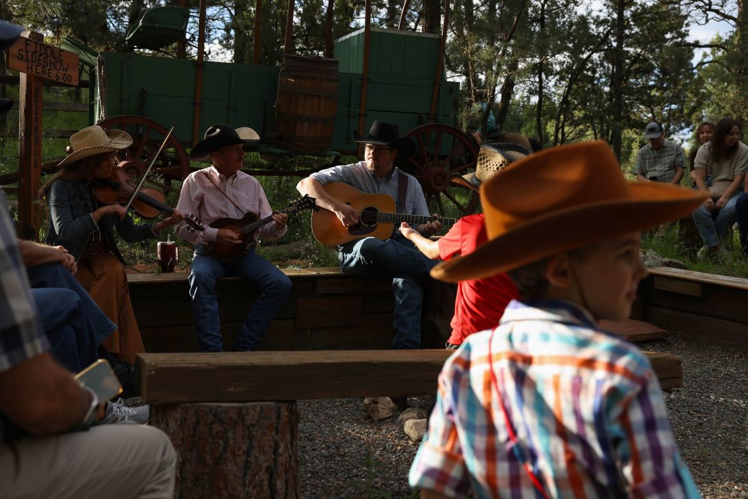 Attendees listen to a band performing at the Flying J Ranch in Alto, New Mexico, on August 28.