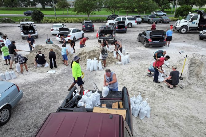 People fill up sandbags in Clearwater, Florida, on September 25.