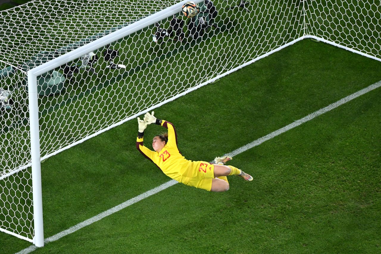 Spain goalkeeper Cata Coll dives as a shot by England's Lauren Hemp hits the crossbar.