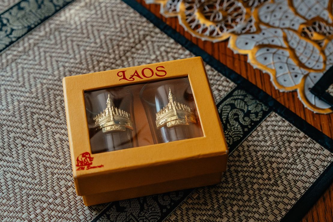 Souvenir shot glasses from Laos sit on a table at Bub's parents' home in July. Bub brought them back after visiting Yang earlier this month.