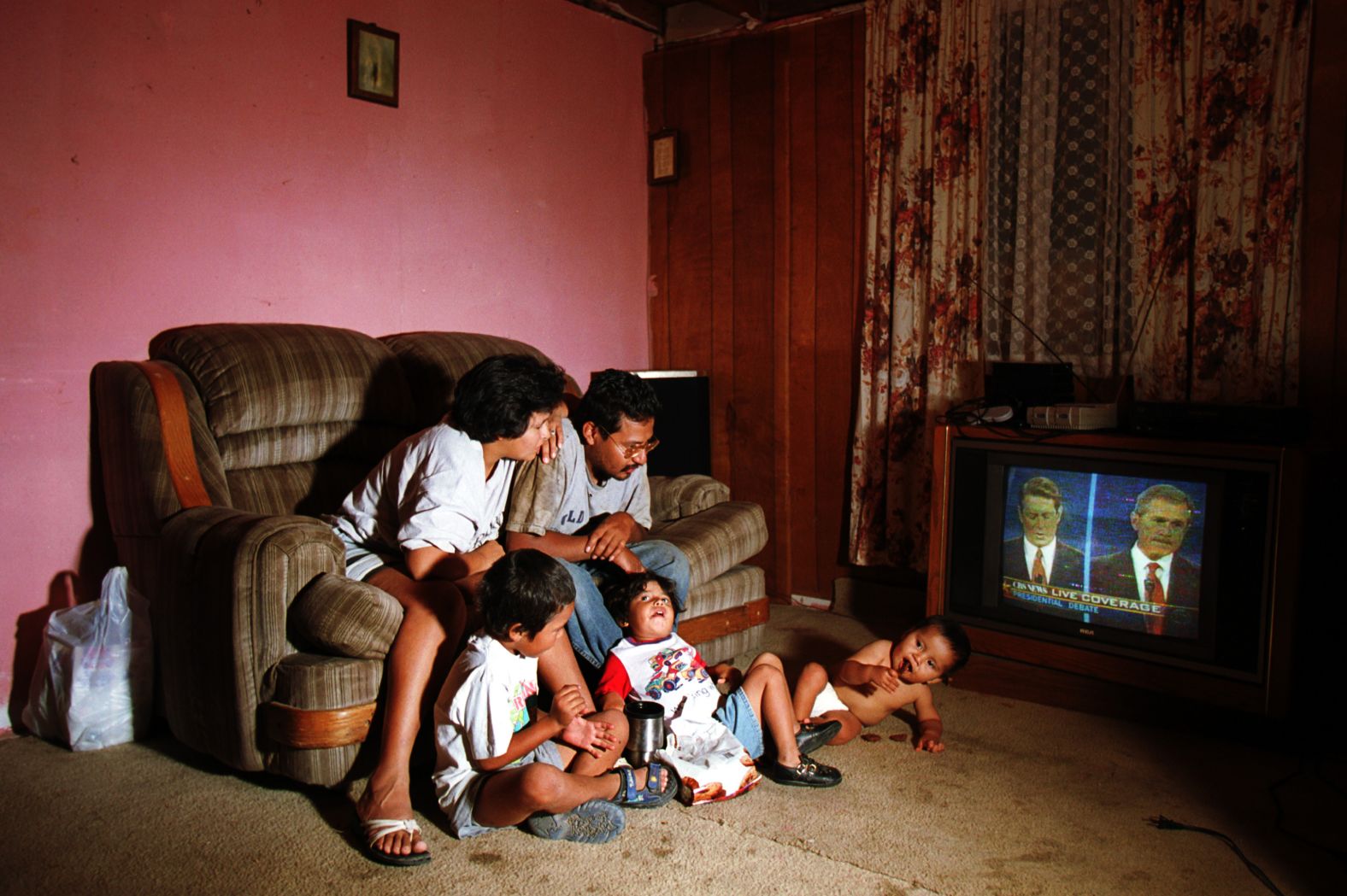 Lorenzo Alvarez is joined by his wife, Angelica, and their three children as they watch the first presidential debate between George W. Bush and Vice President Al Gore in 2000. The couple, which lived on the outskirts of El Paso, Texas, was still undecided about which candidate they would vote for.
