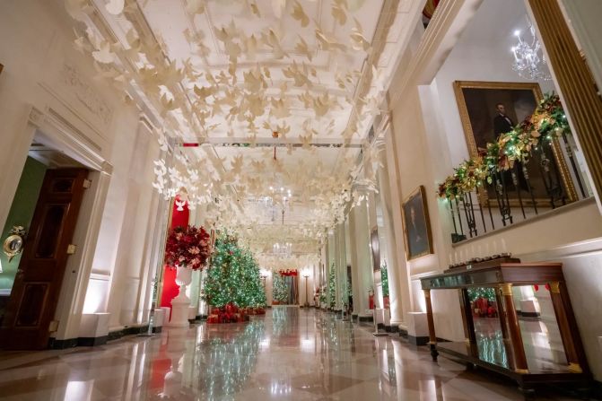 Suspended overhead in the Cross Hall is a cascade of peace doves flying above. The official White House Menorah, created in 2021 by the White House Executive Residence Carpenters’ Shop, is on display in the Cross Hall.