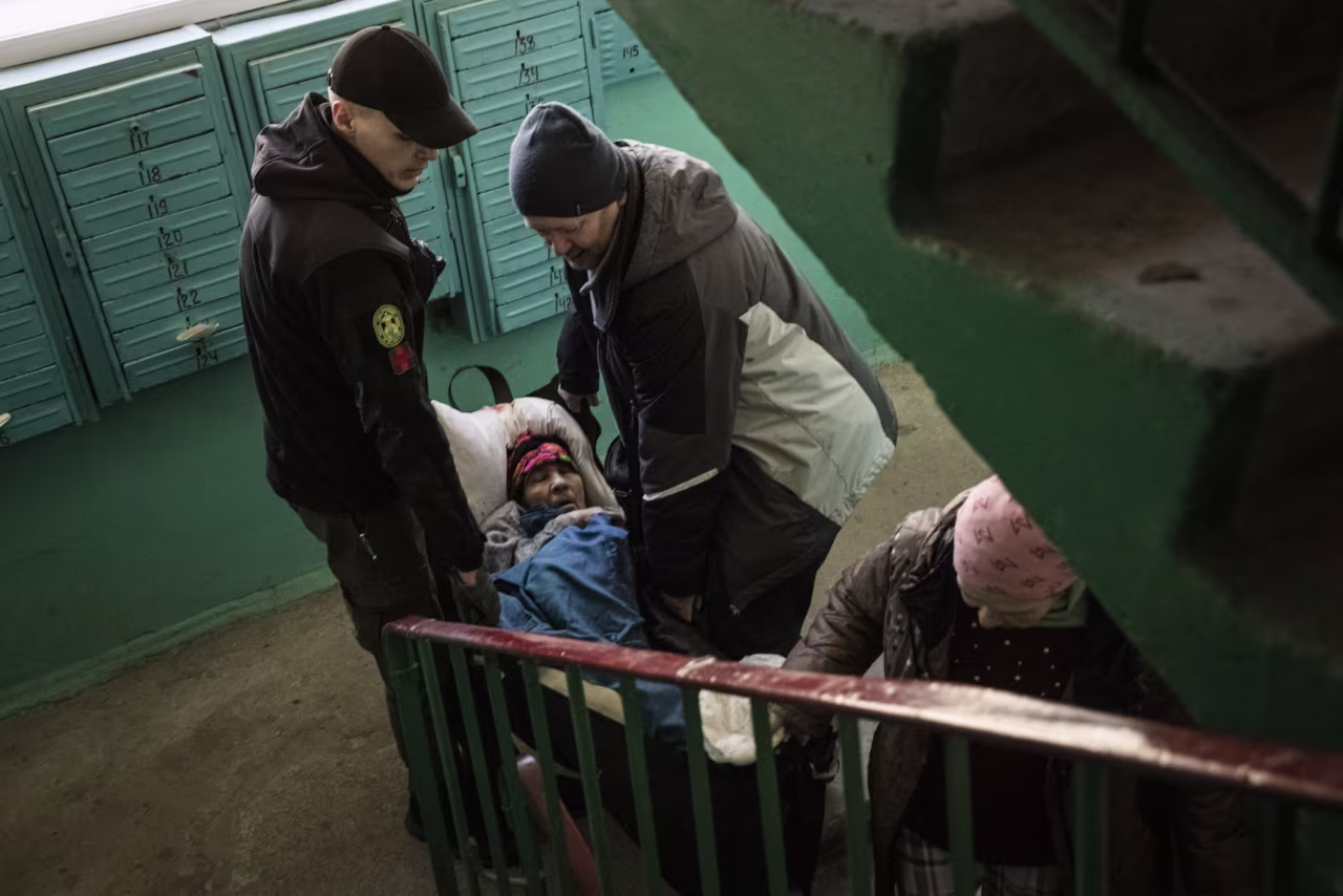 Valentyna Stadnyk, 82, is evacuated from her home in Kramatorsk, Ukraine, by workers with the nongovernmental organization Vostok SOS on March 6. 