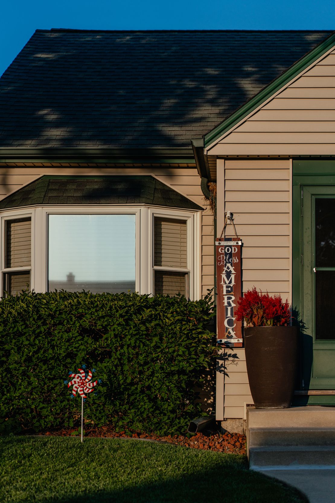 A sign reading "God bless America" hangs by the door of Bub's parents' home in West Milwaukee.