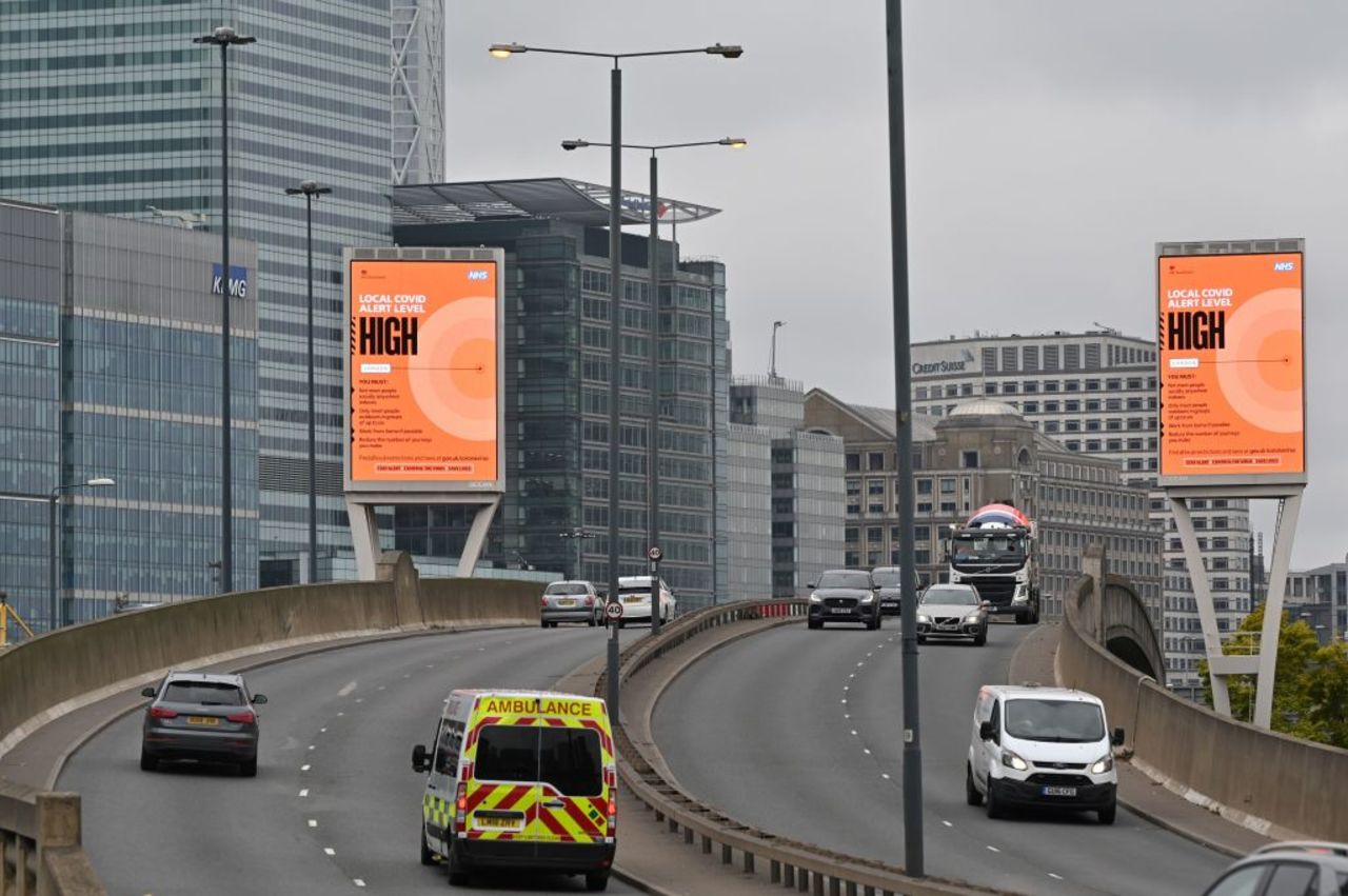 Billboards in London warn commuters of a rise in local infections.