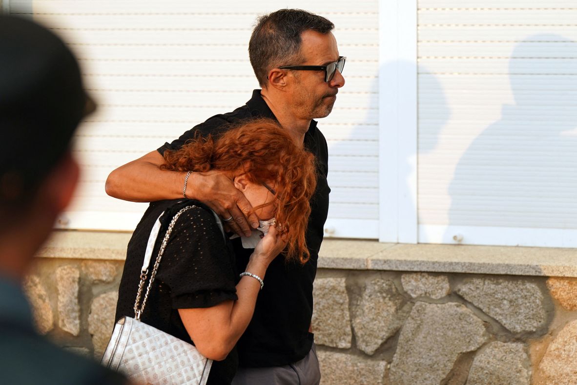 Football agent Jorge Mendes accompanies Isabel Silva, the mother of Jota and Andre Silva, as they leave the funeral home in Spain on Thursday.