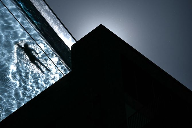A person swims in the Sky Pool, a transparent acrylic swimming pool bridge between apartment blocks in London, on Wednesday, April 30.