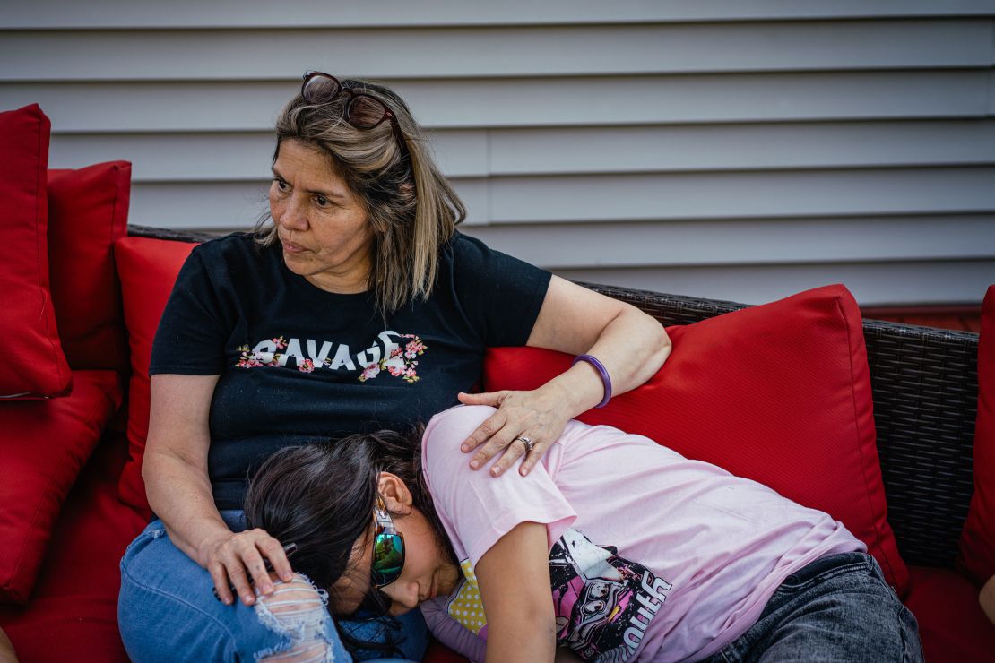 Bub and Yang's twelve-year-old daughter Mila lays on her grandmother Rita Bub’s lap after a video call with Yang.