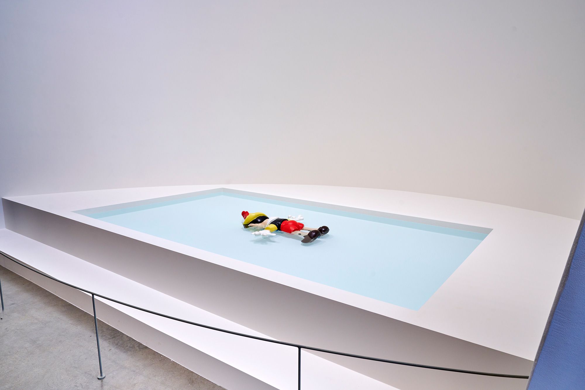 Maurizio Cattelan's bitterly comic piece "Daddy, Daddy" features a Pinnochio figure laying face down in a pool.