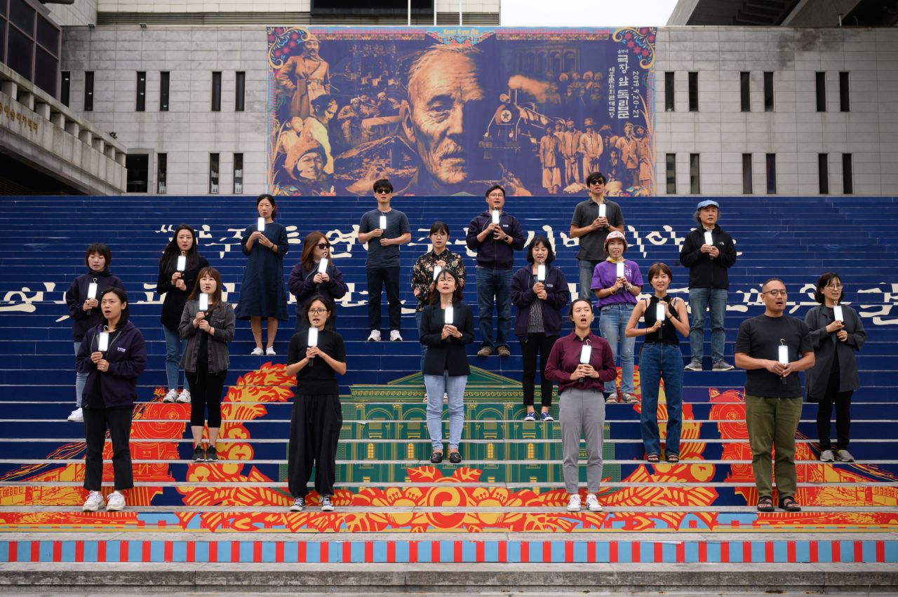 Environmental activists stage a performance as part of a global climate strike in Seoul on Friday.