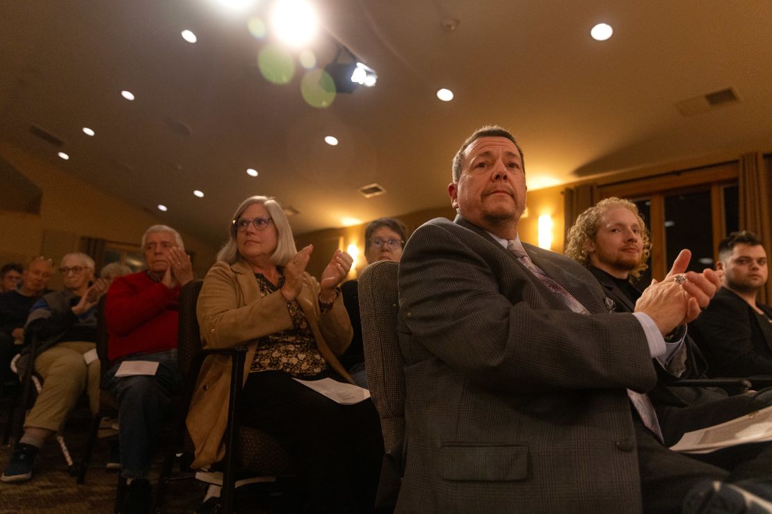 People clap during the event. In November, Delaware residents elected Sarah McBride to congress, making her the first out transgender person to serve. 