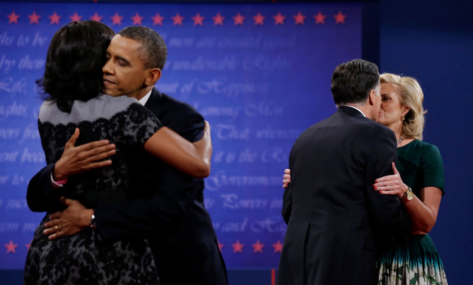 Obama hugs his wife, Michelle, as Romney kisses his wife, Ann, after their third presidential debate in 2012.
