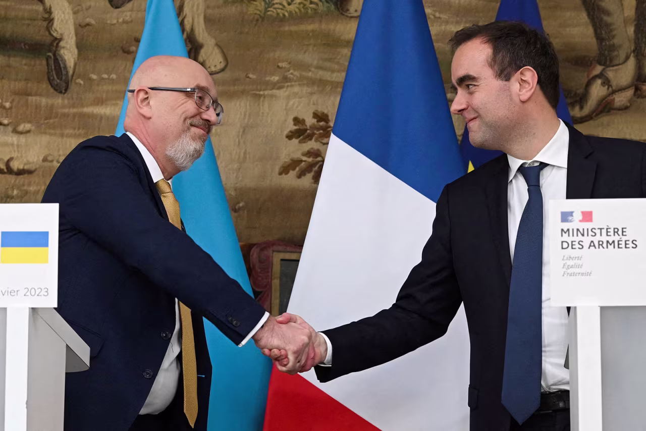 Ukrainian Defense Minister Oleksii Reznikov shakes hands with French Minister of the Armed Forces Sébastien Lecornu during a press conference in Paris on January 31. 