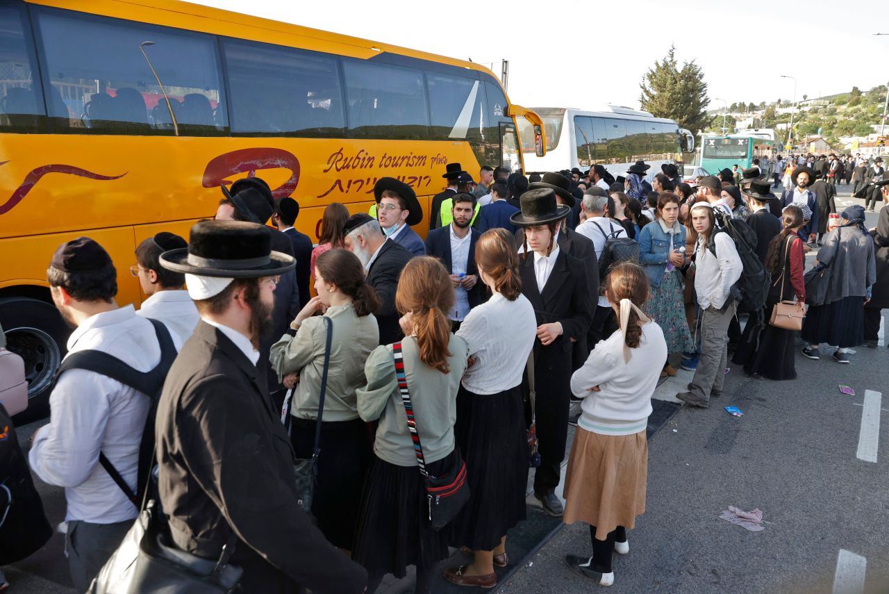 People wait to be evacuated by buses on April 30 in Meron, Israel, following the Lag B'Omer festival.