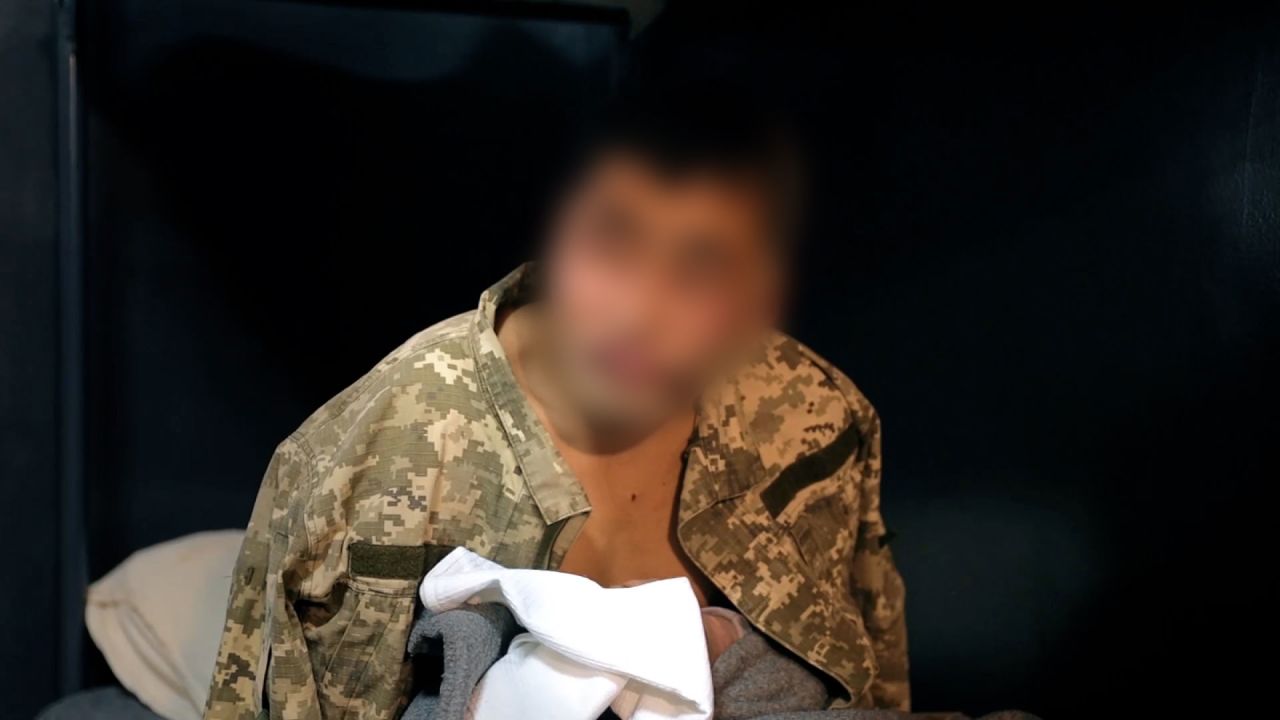 A still from a video shared by Ukrainian President Volodymyr Zelensky on Sunday, January 12, purportedly shows a North Korean POW being interrogated. CNN has blurred part of the image.