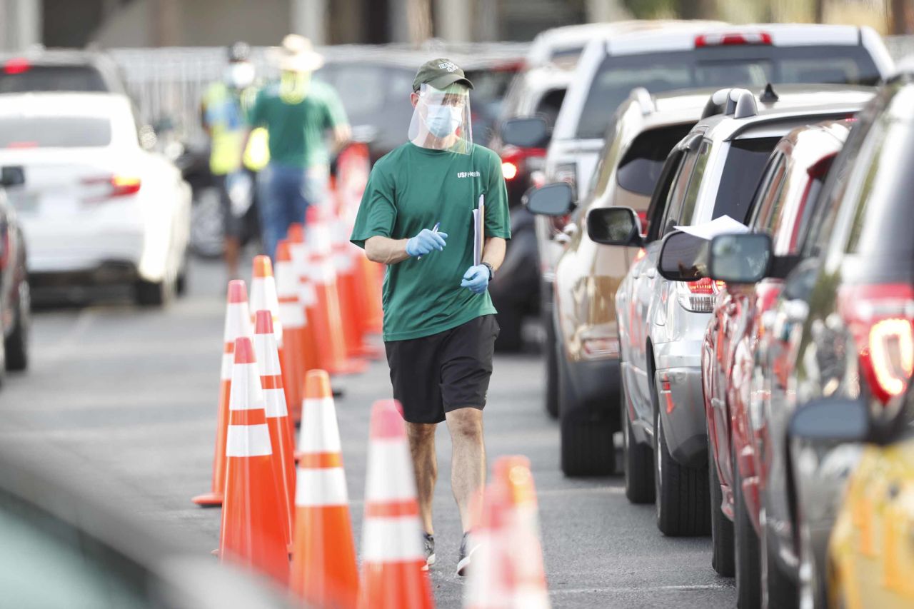 A University of South Florida Health administrator talks to a driver at a coronavirus testing site in Tampa, Florida, on June 25.