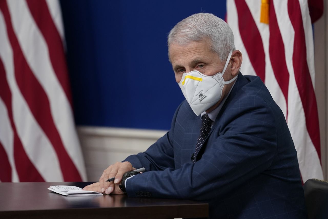 Dr. Anthony Fauci, the top U.S. infectious disease expert, wears a face mask during the White House COVID-19 Response Team's regular call with the National Governors Association in the South Court Auditorium in the Eisenhower Executive Office Building on the White House Campus, Monday, Dec. 27, 2021, in Washington. Fauci says the U.S. should consider a vaccination mandate for domestic air travel as coronavirus infections surge. To date the Biden administration has balked at the idea, anticipating legal entanglements. 