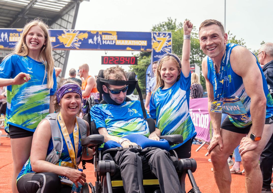 Rob Burrow, wife Lindsey (who ran the half marathon), daughters Macy and Maya and Kevin Sinfield, who ran the full marathon, all pose for a picture after the Rob Burrow Leeds Marathon.