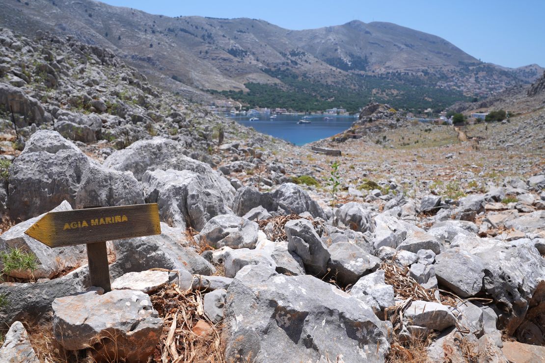 A direction sign on a rocky path in the hills of Pedi, a small fishing village in Symi, pointing toward Agia Marina, where the body of TV doctor and columnist Michael Mosley was discovered.