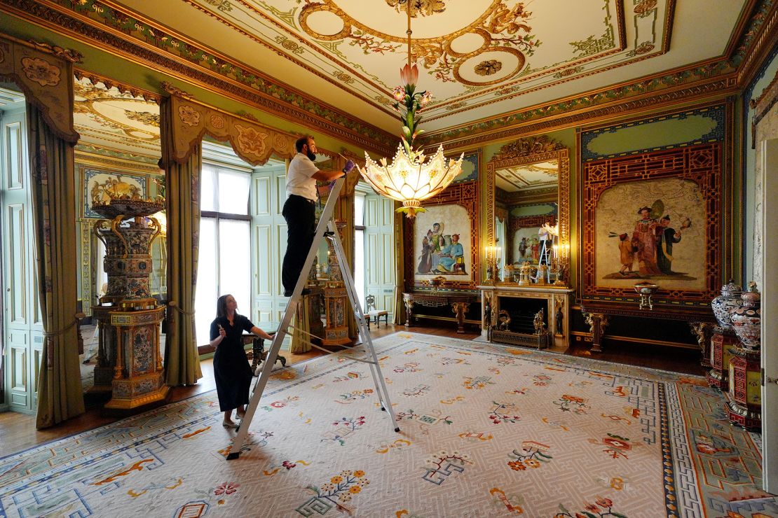 On 8 July, final preparations are made in the Centre Room, where Royal Collection Trust staff are tending to a chandelier.