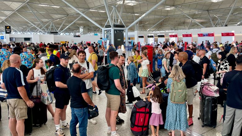 Passengers wait at London Stansted Airport in Essex, amid reports of widespread IT outages affecting airlines, broadcasters and banks. Picture date: Friday July 19, 2024. PA Photo. See PA story TECHNOLOGY Outage . Photo credit should read: Joe Giddens/PA Wire
