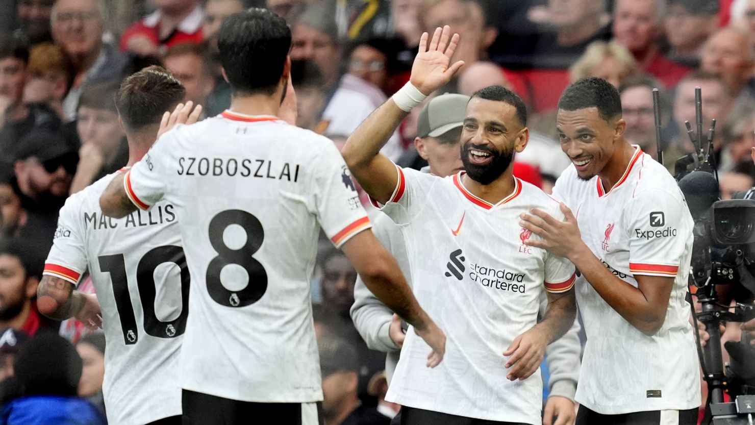 Liverpool players, including Mohamed Salah (second right), celebrate after scoring against Manchester United.