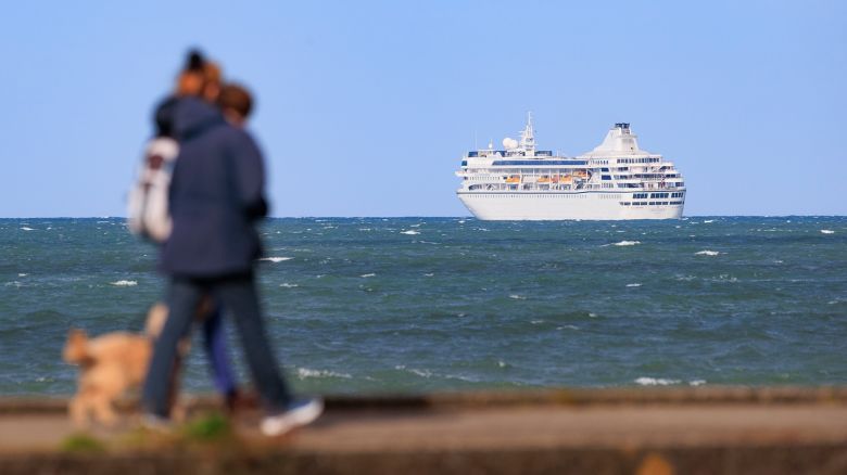 Ann Crawford and her daughter Rachel walk their cockapoo Otto along Bangor Marina, as the Villa Vie Odyssey cruise ship is anchored off the coast of Bangor, Northern Ireland. The luxury cruise ship became marooned in Belfast for four months due to unexpected repair works. Picture date: Tuesday October 01, 2024. PA Photo. See PA story ULSTER CruiseShip. Photo credit should read: Liam McBurney/PA Wire